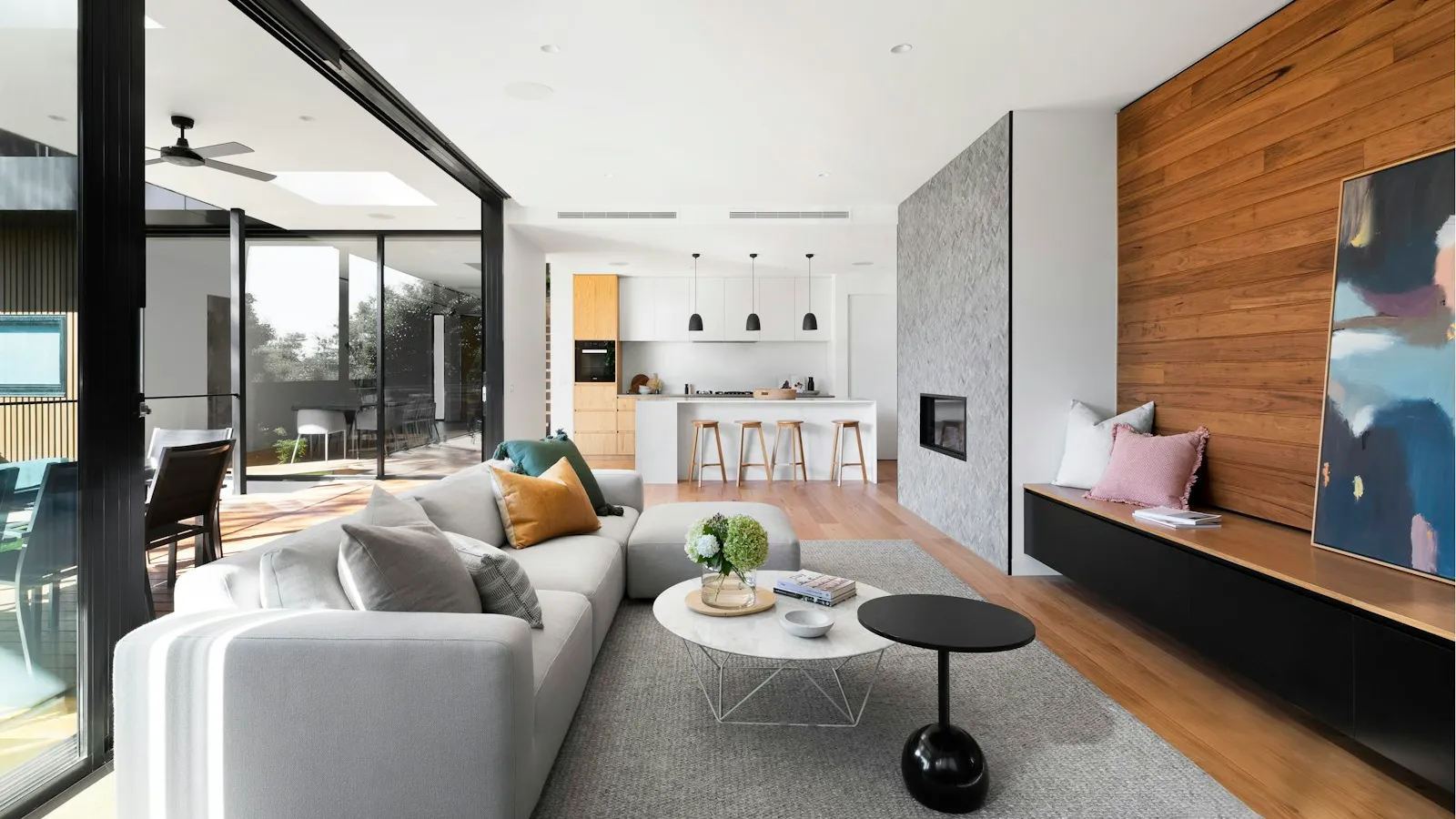 Living room with tall windows looking out over a hillside terrace